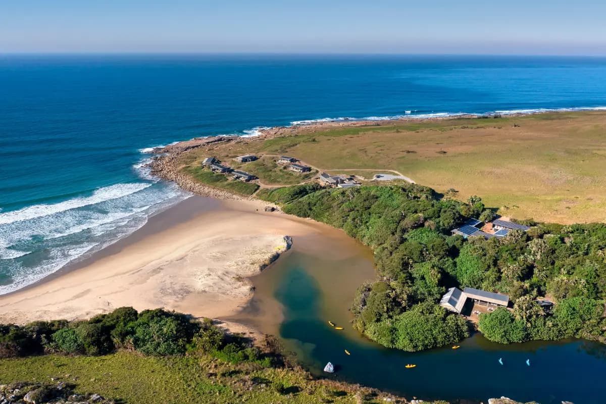 Aerial view of Gwegwe Beach Lodge nestled between the estuary and the Wild Coast shoreline in Mkambathi Nature Reserve