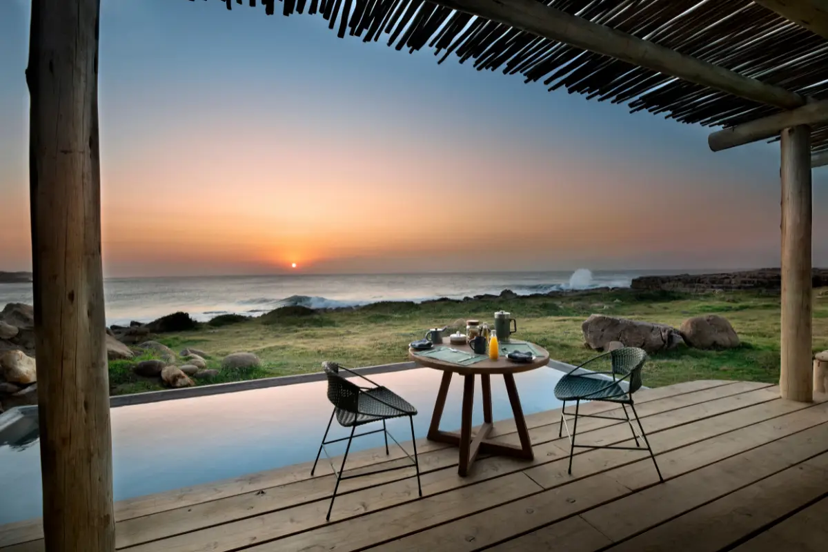 Breakfast table for two on the private deck beside the plunge pool at GweGwe Beach Lodge, Wild Coast sunrise