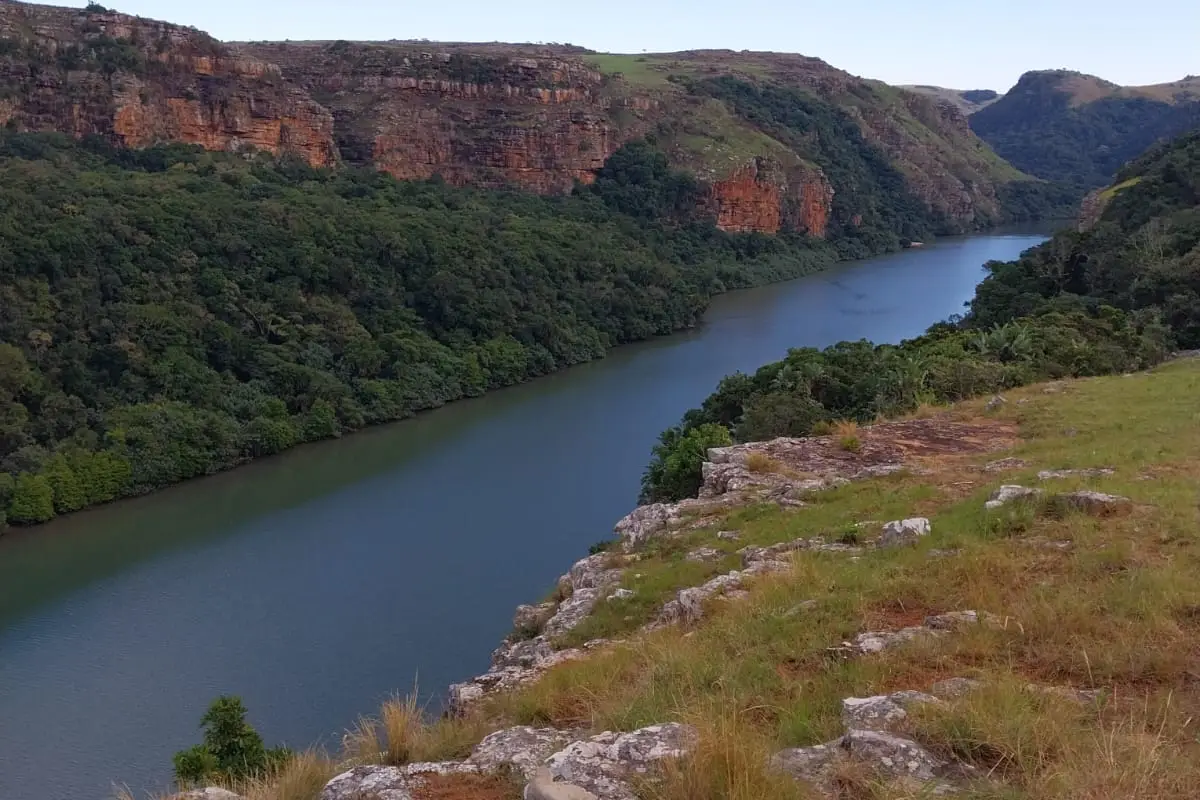Viewpoint above Leopard Rock Falls looking down the Mtentu River gorge with red sandstone cliffs and forested valley