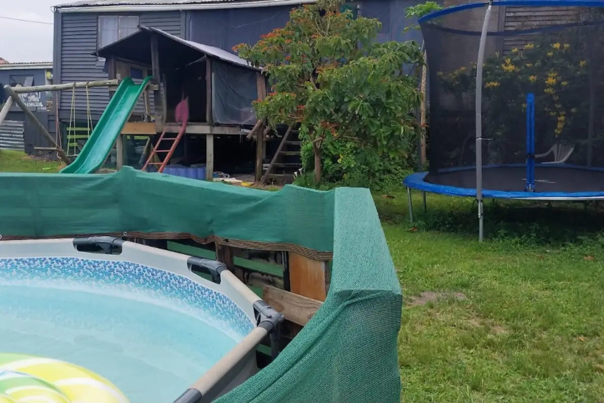 Backyard of the Hiking Shack with a plunge pool, children's slide and trampoline on South Africa's Wild Coast