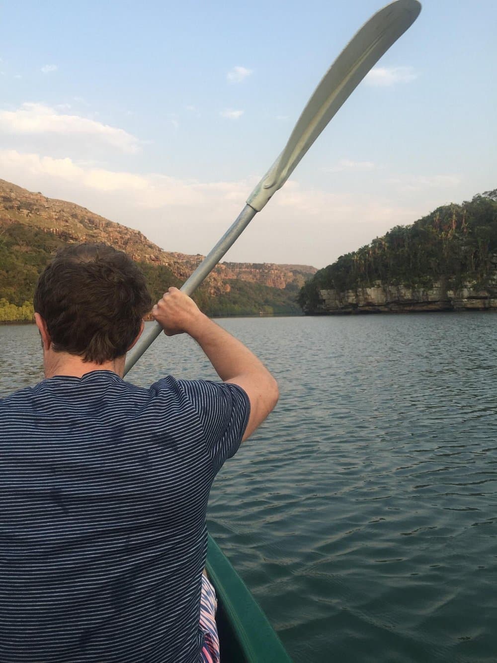 Hiker kayaking through the rocky Mtentu River gorge on a Wild Coast South Africa adventure