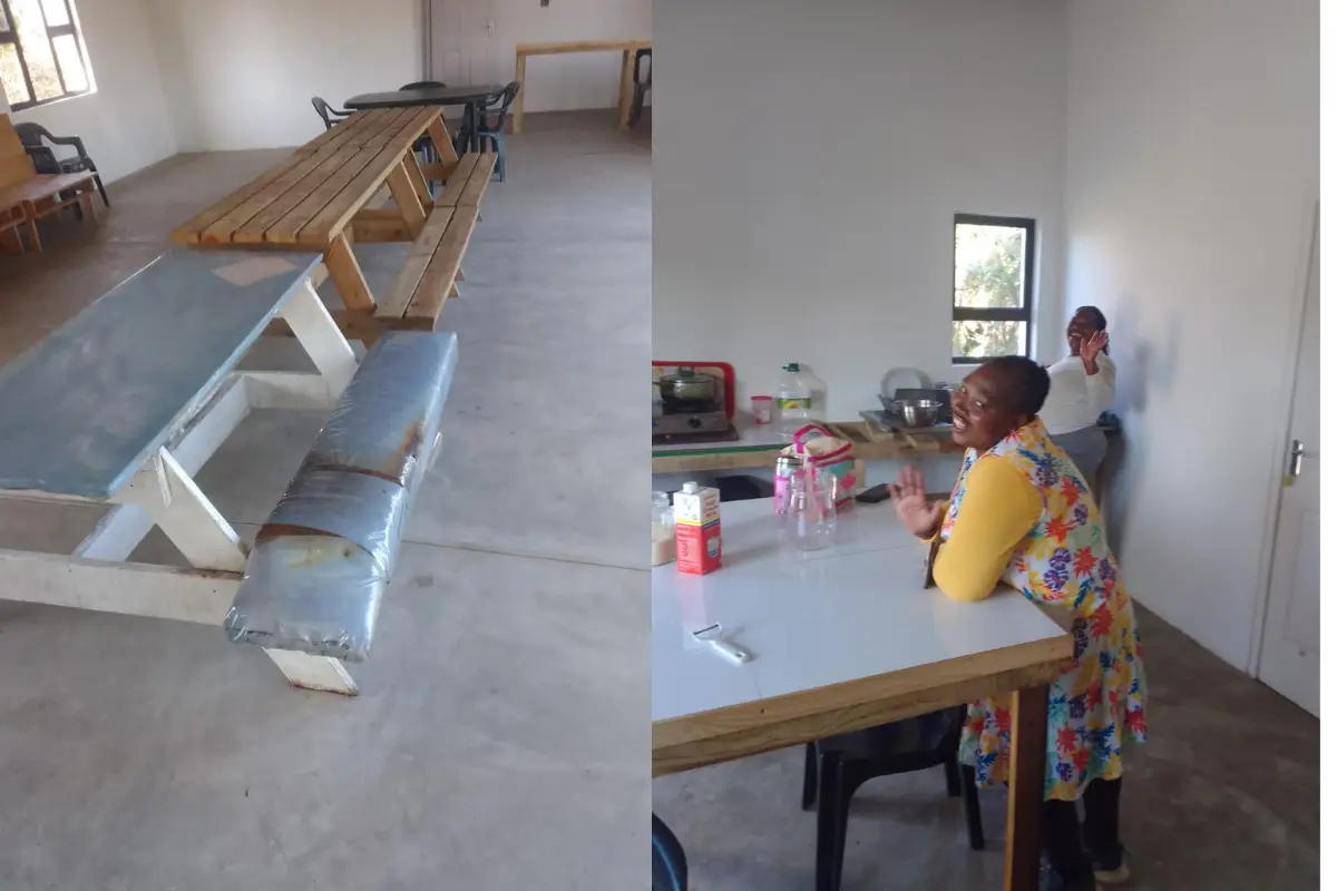 Rebuilt dining hall at Mtentu Lodge with long bench seating and a local staff member cleaning the new space
