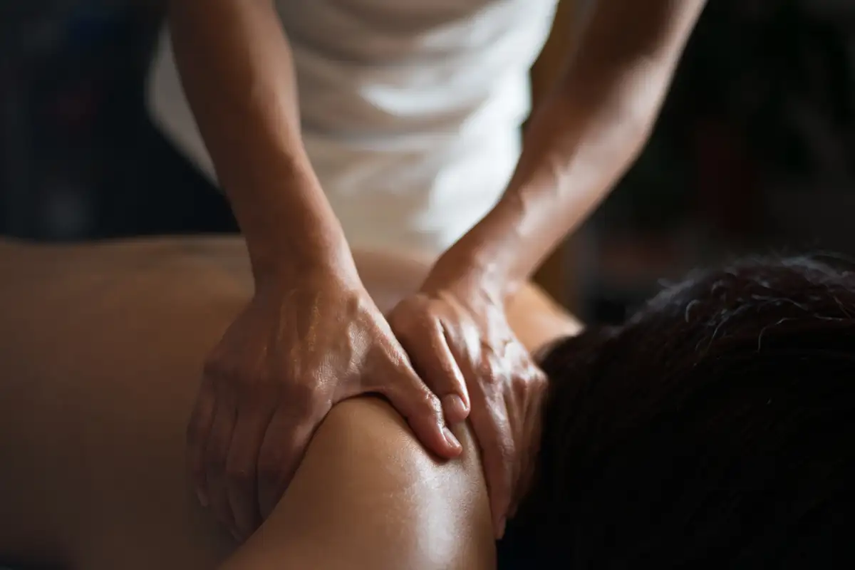 Therapist performing a deep shoulder massage at Pamper Shack on the Wild Coast