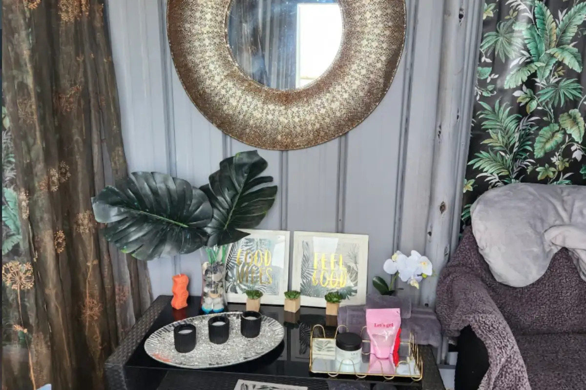 Styled treatment room at Pamper Shack Mtentu River with gold mirror, tropical decor and pamper products