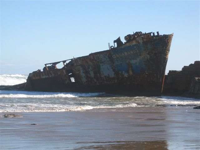 Rusted hull of the MV Jacaranda shipwreck stranded on the Wild Coast shore, Eastern Cape South Africa